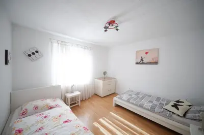 a bedroom with a bed and a window at Sunset Apartments Bohinj in Bohinj