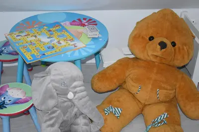 two stuffed teddy bears sitting next to a table at Sunset Apartments Bohinj in Bohinj
