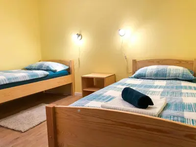 a bedroom with two beds and two night stands at Apartma Bubi in Bovec