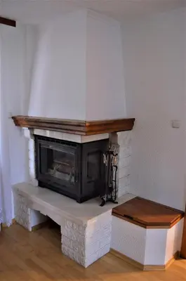 a living room with a brick fireplace with at Apartma Bubi in Bovec