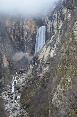 a waterfall on the side of a mountain at Apartma Bubi in Bovec
