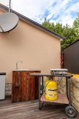 a table and a yellow bucket on a deck at Casa Badiha in Zgornje Škofije