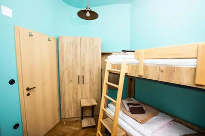 a bunk bed room with two bunk beds and a ladder at Dežnik in Ljubljana
