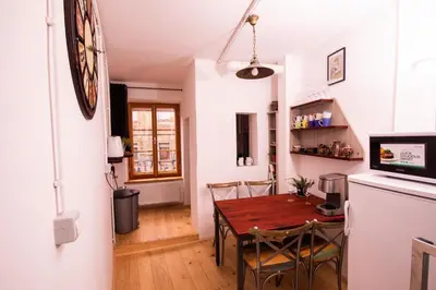 a kitchen and dining room with a table and chairs at Dežnik in Ljubljana