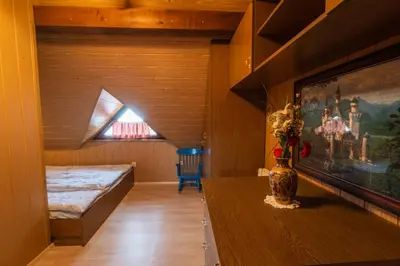a room with a bed and a vase on a table at Vineyard cottage Hočevar in Novo Mesto