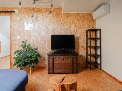 a living room with a tv on a wooden table at Apartment Vrhouc in Tolmin