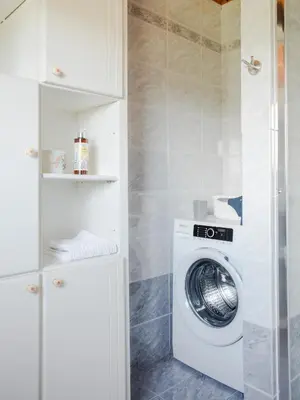 a white washer and dryer in a bathroom at Apartment Vrhouc in Tolmin