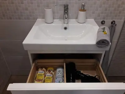 a bathroom sink and a drawer under a sink at Alpine Cottage in Bled