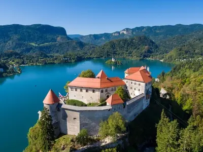 an island in the middle of a lake with a castle at Alpine Cottage in Bled
