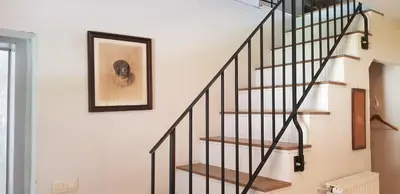 a spiral staircase in a home with a picture on the wall at The OldMillhouse in Mojstrana