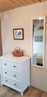 a white dresser in a room with a mirror at The OldMillhouse in Mojstrana