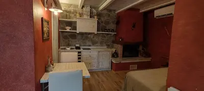a room with a kitchen with a counter and a table at ČEBRON FAMILY ESTATE in Branik