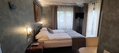 a bedroom with a large bed and a window at ČEBRON FAMILY ESTATE in Branik