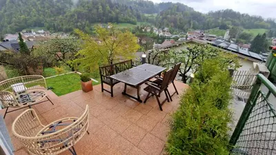a patio with a table and chairs on a balcony at Bergmannhaus in Zagorje ob Savi