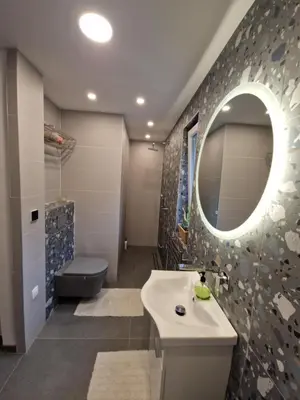 a bathroom with a sink and a mirror and a toilet at Bergmannhaus in Zagorje ob Savi