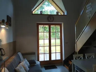 a living room with a large window and a couch at Apartment Trobentica 40 Moravske Toplice - SPA in Moravske Toplice