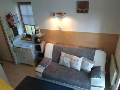 a living room with a couch with pillows on it at Apartment Trobentica 40 Moravske Toplice - SPA in Moravske Toplice
