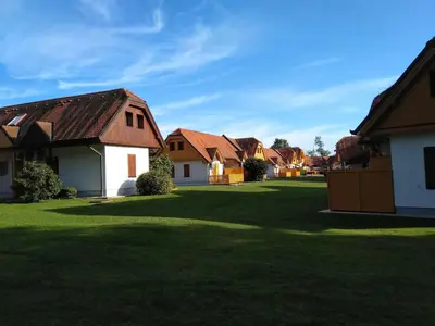 a row of houses in a green yard at Apartment Trobentica 40 Moravske Toplice - SPA in Moravske Toplice