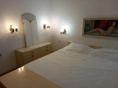 a bedroom with a white bed and a mirror at Country House Aleš in Gornja Bistrica