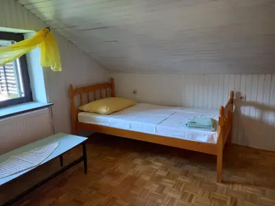 a small room with a bed and a window at Country House Aleš in Gornja Bistrica