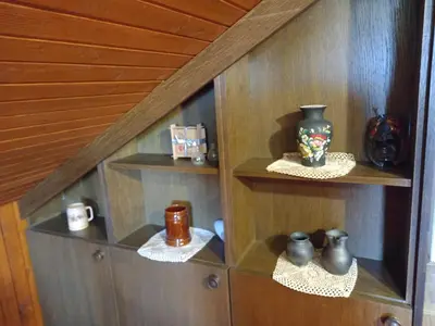 a wooden shelf with vases and cups on it at Country House Aleš in Gornja Bistrica