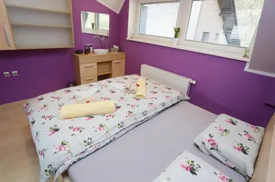a small bedroom with a bed with a candle on it at Lux Living Apartments BUDIČ near Terme Čatež in Brežice