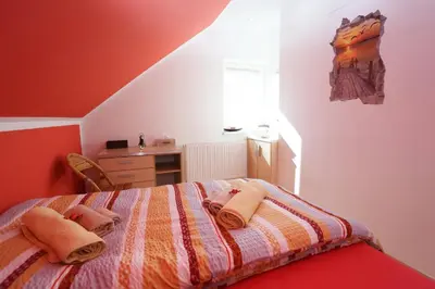 a bedroom with a bed with towels on it at Lux Living Apartments BUDIČ near Terme Čatež in Brežice