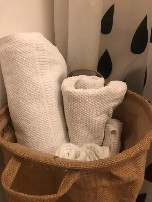 a basket filled with towels and toiletries at Birch central studio on main square in Ljubljana