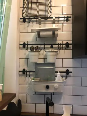a bathroom with a sink and buckets on a wall at Birch central studio on main square in Ljubljana