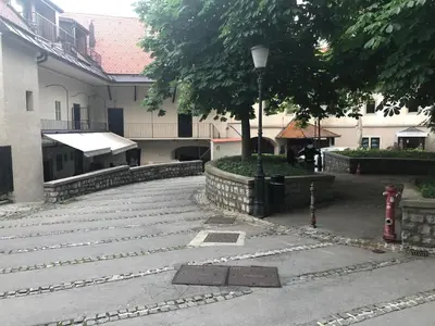 a building with a street light next to a sidewalk at Birch central studio on main square in Ljubljana