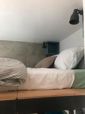 a bed sitting on top of a wooden shelf at Birch central studio on main square in Ljubljana