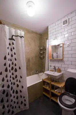 a bathroom with a tub and a toilet and a sink at Birch central studio on main square in Ljubljana