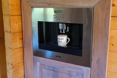 a cup of coffee sitting inside of a microwave at House of Nature Tajhte in Planina pri Sevnici
