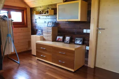 a room with a dresser with pictures on it at House of Nature Tajhte in Planina pri Sevnici