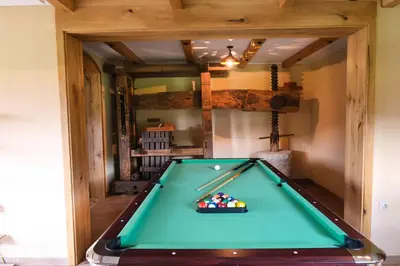 a snooker table in a room with a pool at House of Nature Tajhte in Planina pri Sevnici