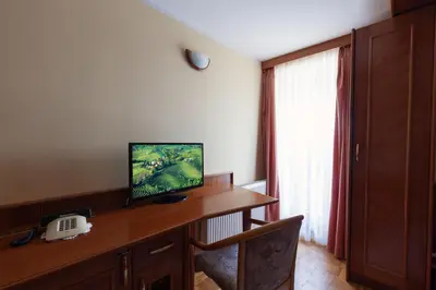a room with a desk with a telephone and a window at Gostišče Prosnik in Ormoz