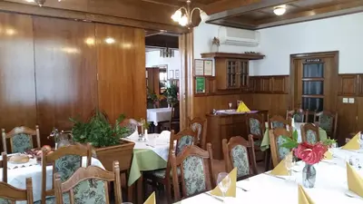 a restaurant with tables and chairs in a room at Gostišče Prosnik in Ormoz