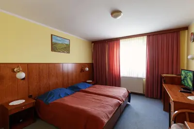 a hotel room with a bed and a desk at Gostišče Prosnik in Ormoz