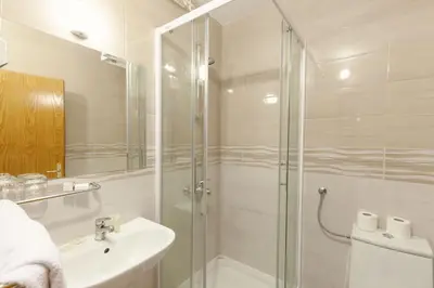 a bathroom with a glass shower and a sink at Gostišče Prosnik in Ormoz