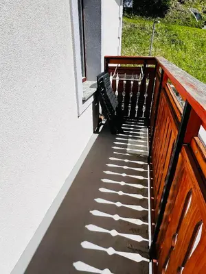 a balcony with a bench on the side of a building at Apartma Lip in Rateče