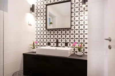 a bathroom with a sink and a mirror on a wall at Castle way Apartments Tamy in Bled