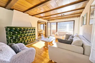 a living room with two couches and a table at Castle way Apartments Tamy in Bled