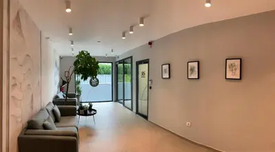 a hallway of a home with a living room with couches at Regentova Suites Ljubljana in Ljubljana