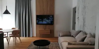 a living room with a couch and a table at Regentova Suites Ljubljana in Ljubljana