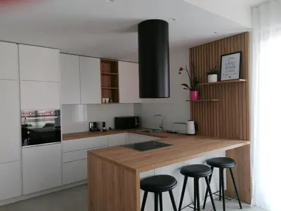 a kitchen with a counter and stools in it at Regentova Suites Ljubljana in Ljubljana