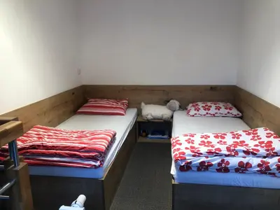 two beds in a room with red and white blankets at BC10 in Bovec