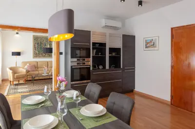 a kitchen and dining room with a table and chairs at Villa Magnolia in Ljubljana