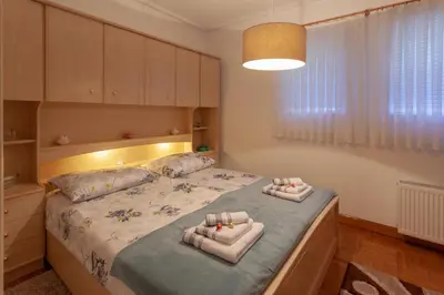 a bedroom with a bed with two towels on it at Villa Magnolia in Ljubljana