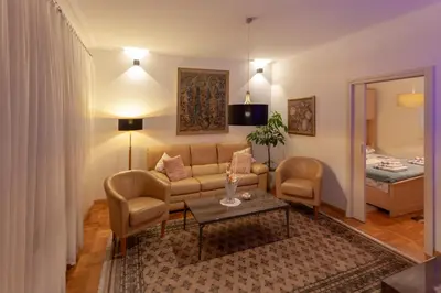 a living room with a couch and two chairs at Villa Magnolia in Ljubljana