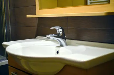 a bathroom sink with a faucet and a mirror at Sunset Bled in Bled
